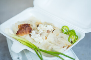 Thai fresh spring rolls stuffing with fresh vegetable, sprouts, vegetables wrapped with rice sheet dough topping with crab meat and fresh chili served with special gravy