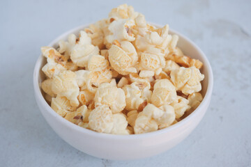  popcorn in a bowl on wooden desk