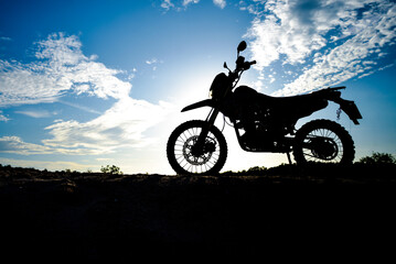 Beautiful evening motocross motorcycle silhouette on the mountain