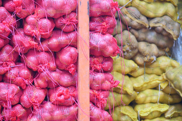 Fototapeta premium stack of red onion in bags