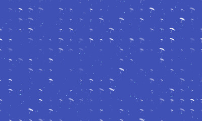 Seamless background pattern of evenly spaced white umbrella symbols of different sizes and opacity. Vector illustration on indigo background with stars