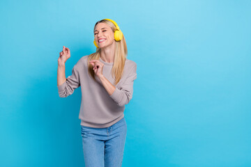 Photo of satisfied positive lady dressed stylish clothes eyes closed enjoy new modern accessory empty space isolated on blue color background