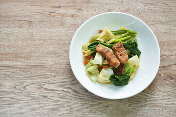 fried Chinese kale and cabbage with gluteb crispy pork vegetarian food on plate