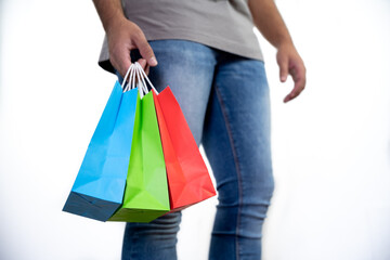 Unrecognizable young man holding some colorful bags - concept shopping, black friday, sales, christmas