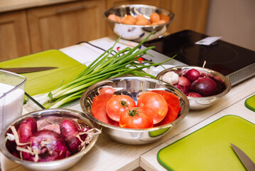 Cooking tables (working stations) prepared before the cooking master class. Cutting boards, raw food, kitchen utensils.