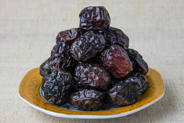 Delicious ajwa dates ( kurma nabi ), Much sought after during the month of Ramadan as a dish for breaking the fast, ramadhan kareem, empty space, copy space.