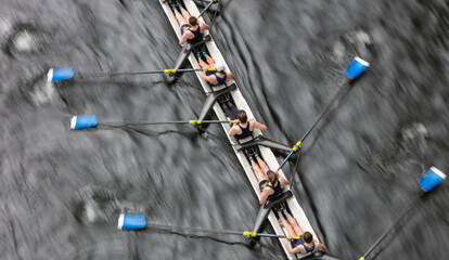 Overhead view of female crew racers rowing in an octuple racing shell, an eights team.