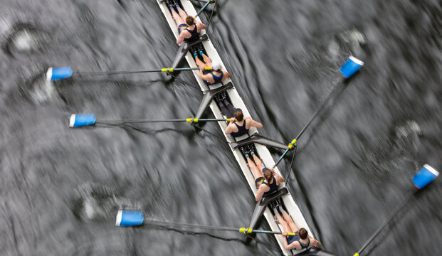 Overhead view of female crew racers rowing in an octuple racing shell, an eights team.