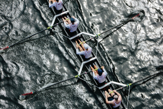 Overhead view of female crew racers rowing in an octuple racing shell, an eights team.