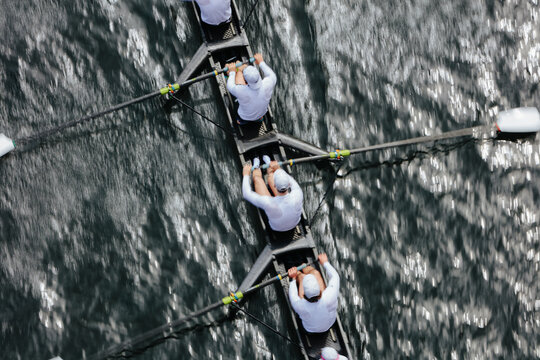 Overhead view of female crew racers rowing in an octuple racing shell, an eights team.