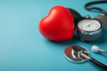 Gray tonometer and heart mockup on a blue background. Medical equipment blood pressure monitor....