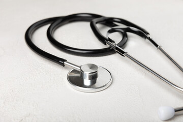 Black stethoscope on a gray background. Health care and medicine concept.health and doctor symbols.Close-up. Place to copy.