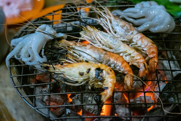 Grilled shrimp and squid on hot charcoal
