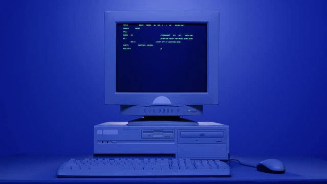 Retro pc with loading code console, programmer making scripts, green basic screen, Old computer studio blue night background close-up, Desktop vintage retro wave display, late 90s PC.