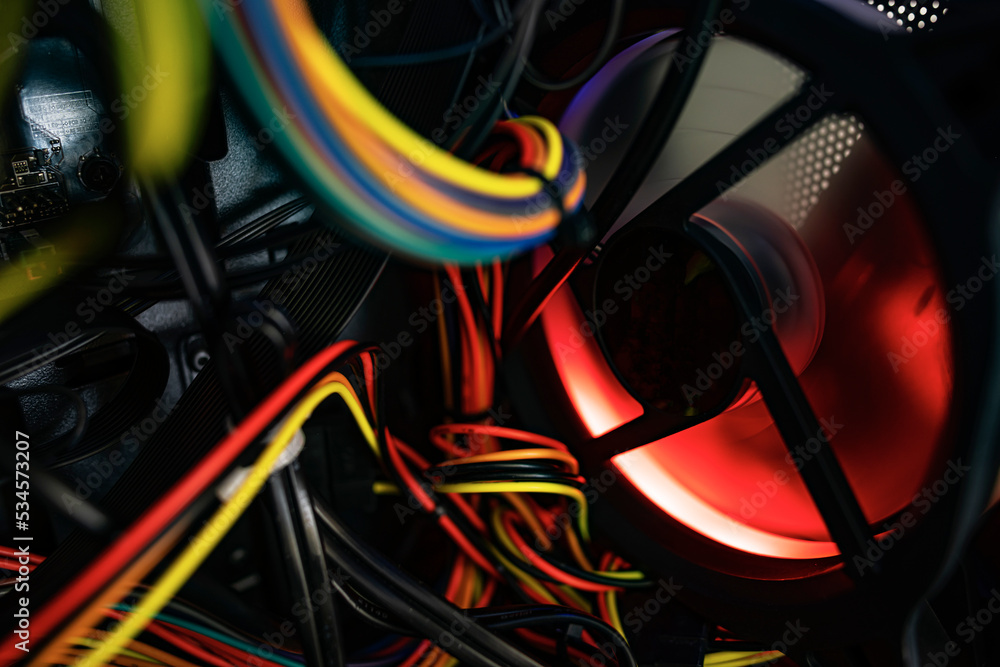 Poster glowing computer cooler while working close-up. inside the computer.