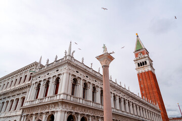 Fototapeta na wymiar Historical landmarks and people walking at St. Mark's Square, Venice, Italy.