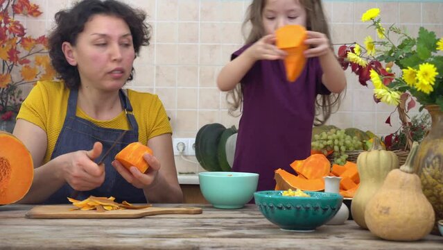 Thanksgiving Tradition, Pumpkin Pie. Happy mother and child cooks pumpkin pie for harvest festival. Festive dinner cooking with family