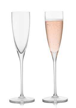 Empty and full pink rose champagne crystal glasses on white background.