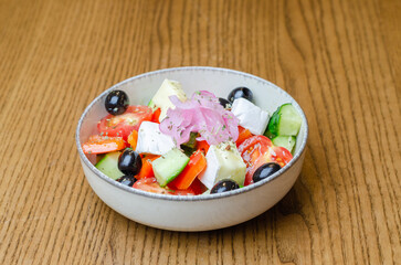 Greek salad in a plate on the table