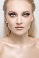 Fashion and make-up concept. Beautiful blonde girl with green eyes studio portrait. Sexy looking...