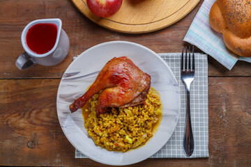 Rosh Hashanah next to fruit wine and challah on the table and candles next to a duck's leg and...