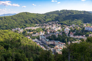 Fototapeta na wymiar Karlovy Vary, Czech Republic - August 7, 2022: View of the city of Karlovy Vary from the Diana Watchtower, a lookout tower in the spa town of Karlovy Vary.