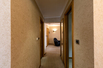 Interior of a hotel apartment corridor with doors