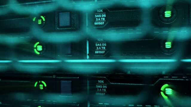 Storage server with many HDD disks SAS inside rack in server room.