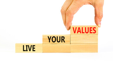 Live your values symbol. Concept words Live your values on wooden blocks. Businessman hand....