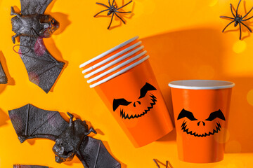 Halloween party background with Paper cup with Jack lantern face decoration. Disposable cup made of...