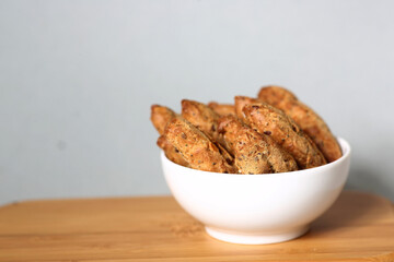 small French baguettes in a bowl against gray background