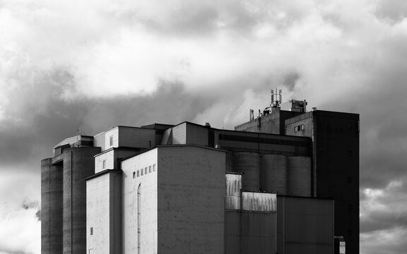 grain silo building with clouds