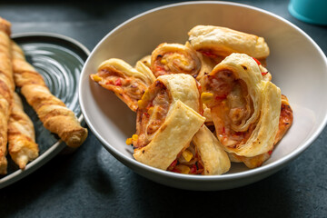 a roll of puff pastry with the addition of cheese, ham and pepper in the company sticks of puff pastry. Party snacks