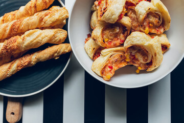 a roll of puff pastry with the addition of cheese, ham and pepper in the company sticks of puff pastry. Party snacks