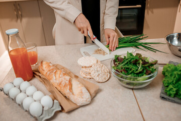 Close up of woman preparing vegetable vegan salad in the kitchen. Healthy food and diet concept lifestyle. Cook at home