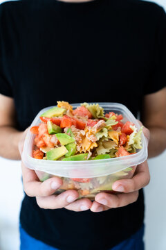 Hands Holding A Healthy Mediterranean Pasta Salad Tupperware