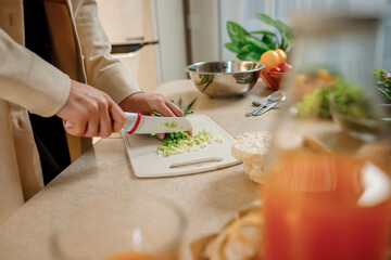 Close up of woman preparing vegetable vegan salad in the kitchen. Healthy food and diet concept lifestyle. Cook at home