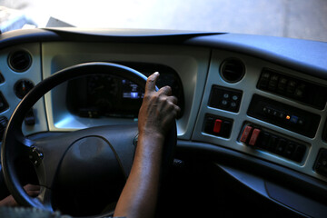 Man driving a car with his two hands on the steering wheel