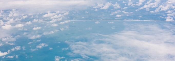 Panorama Aerial view of peaceful earth coastline through beautiful clouds