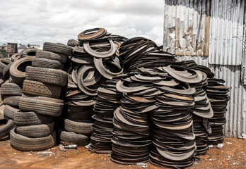 There are tons of tires for sale, most of which are used for fuel and crafts - stack of tires in a factory