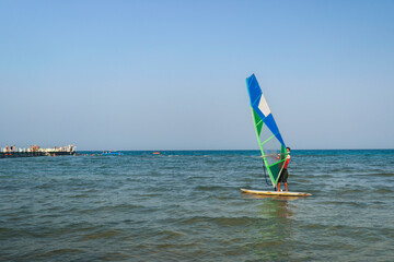 a man is windsurfing by the sea