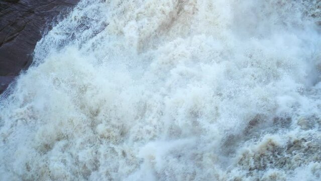 Turbulent water in the rapids of a raging river torrent