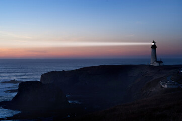 Lighthouse and beam at dusk © John