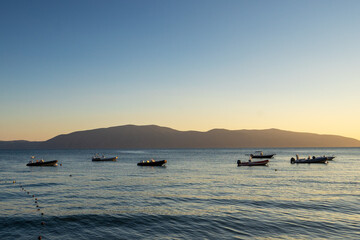 Fototapeta na wymiar Fishing boats at sunset time in vlore, albania.