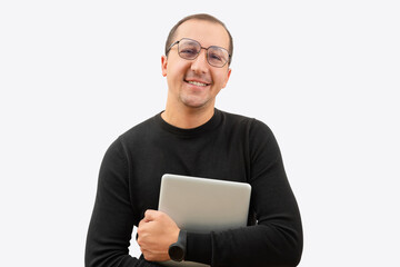 Young smiling man in glasses and laptop in hands isolated on gray background
