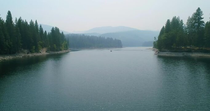 Sweeping drone shot of a lake on a summer day. 