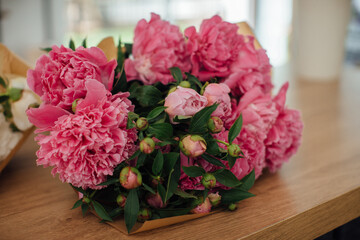 Peonies on a table in a flower shop, close-up.