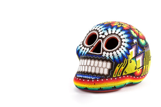 Colorful skulls, Mexican handicrafts. Day of the Dead, handmade Huichol figure of chaquira, Mexico