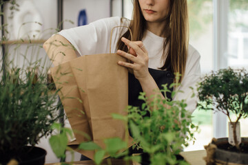 A young woman works in her flower shop. Small business concept.