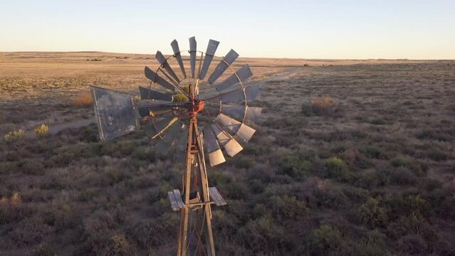 Aerial of farm windmill and water pump